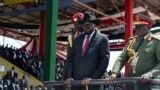 FILE - South Sudan's President Salva Kiir, center, accompanied by army chief of staff Paul Malong Awan, right, attends an independence day ceremony in the capital Juba, South Sudan, July 9, 2015.