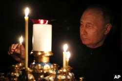 Putin pali svijeću žrtvama napada u hali Crocus City. (Foto: AP/Mikhail Metzel, Sputnik, Kremlin Pool)