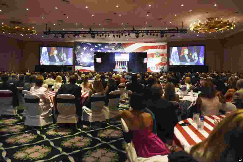 Audience members listen to President Donald Trump's remarks at a Salute to Service at a Salute to Service charity dinner in conjunction with the PGA Tour's Greenbrier Classic at The Greenbrier in White Sulphur Springs, W.Va., Tuesday, July 3, 2018. 