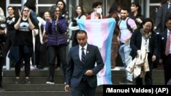 FILE- Washington Attorney General Nick Brown walks down the steps of a federal court in Seattle after a hearing over President Donald Trump's order against gender-affirming care for youth, Feb. 28, 2025.