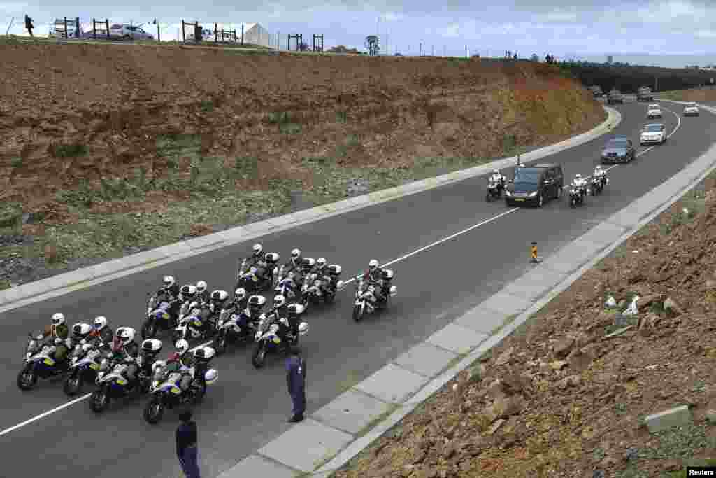 The funeral cortege carrying the coffin of former South African President Nelson Mandela drives through Mandela's homeland just outside the village of Qunu December 14, 2013. Mandela will be buried in his family homestead in Qunu on Sunday after a state f