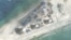 FILE - Construction is shown on Fiery Cross Reef, in the Spratly Islands, the disputed South China Sea in this March 9, 2017, satellite image released by CSIS Asia Maritime Transparency Initiative at the Center for Strategic and International Studies (CSIS).