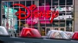 FILE - The logo of the Times Square Disney store is seen in Times Square, New York City, Dec. 5, 2019. 