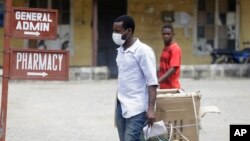 A man wearing face mask walks at the Yaba Mainland hospital where an Italian citizen who entered Nigeria on Tuesday from Milan on a business trip, the first case of the COVID-19 virus is being treated in Lagos Nigeria, Feb. 28, 2020.