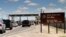 FILE - This Sept. 9, 2014 file photo shows cars waiting to enter Fort Bliss in El Paso, Texas. The base is one of three Texas military properties to be considered as a shelter location for unaccompanied migrant children.