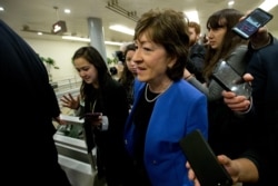 FILE - Senator Susan Collins talks to reporters before attending the impeachment trial of then-President Donald Trump on charges of abuse of power and obstruction of Congress, Jan. 28, 2020, on Capitol Hill in Washington.