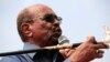 FILE - Then-Sudan's President Omar al-Bashir addresses supporters during his visit to the war-torn Darfur region, in Bilal, Darfur, Sudan Sept. 22, 2017. 