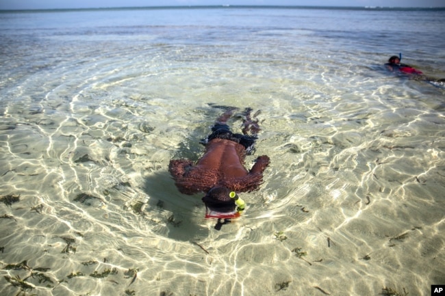 FILE - A student takes part in a guided snorkel lesson led by marine biologist Jean Wiener at Caracol Bay near Cap-Haitien, Haiti, Wednesday, March 9, 2022. (AP Photo/Odelyn Joseph)