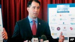 FILE - Wisconsin Gov. Scott Walker speaks at a news conference in Madison, Wis., Jan. 30, 2018. Walker signed sweeping GOP legislation Friday to restrict early voting and weaken the incoming governor and attorney general, both Democrats.