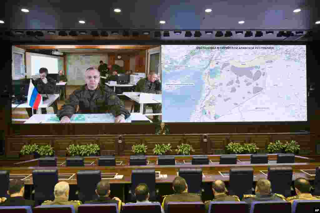 Lt.-Gen. Sergei Rudskoi of the Russian Military General Staff, background center, speaks to the media in Moscow, Feb. 27, 2016. A top military official said Russia has halted airstrikes in areas where armed groups said they would abide by a cease-fire.