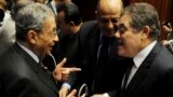 Amr Moussa (L), head of the assembly writing Egypt's new constitution, speaks with El-Sayed El-Badawi (R), the head of the Wafd party, before a vote at the Shura Council in Cairo, Dec. 1, 2013. 