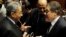 Amr Moussa (L), head of the assembly writing Egypt's new constitution, speaks with El-Sayed El-Badawi (R), the head of the Wafd party, before a vote at the Shura Council in Cairo, Dec. 1, 2013.