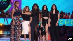 FILE - Dinah Jane Hansen, from left, Ally Brooke, Normani Kordei, Camila Cabello and Lauren Jauregui, of Fifth Harmony, present the Choice Style Icon award at the Teen Choice Awards at the Galen Center in Los Angeles, Aug. 16, 2015.