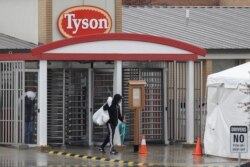 FILE - A Tyson Fresh Meats plant employee leaves the plant, in Logansport, Ind., April 23, 2020.