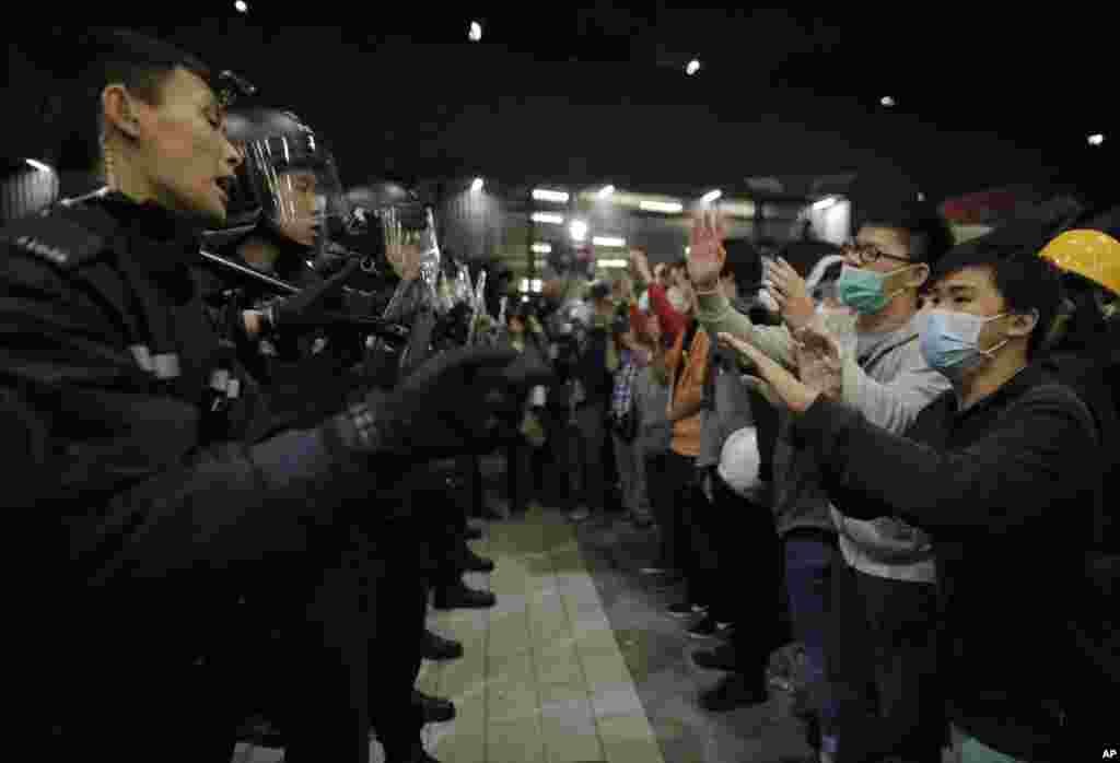 Police officers tell the protesters not to push after the protesters tried to break into the Legislative Council in Hong Kong, Nov. 19, 2014.