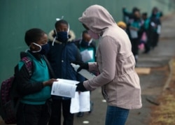 Students go through the regular morning checks on their arrival at the Melpark Primary School in Johannesburg, South Africa, Sept. 3, 2020.