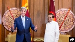 FILE - U.S. Secretary of State John Kerry, center left, poses with Sri Lankan President Maithripala Sirisena before a meeting in the presidential meeting room at the Presidential Secretariat, Saturday, May 2, 2015, in Colombo, Sri Lanka.