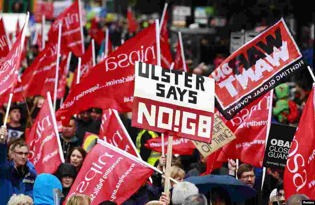 Protesters wave placards and flags during an anti-G8 demonstration ahead of the summit, at Belfast City Center. Leaders of the G8 countries will meet at Lough Erne in Northern Ireland for the summit on June 17-18. 