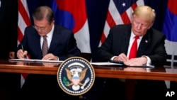 President Donald Trump, right, and South Korean President Moon Jae-In participate in a signing ceremony for the United States-Korea Free Trade Agreement at the Lotte New York Palace hotel during the U.N. General Assembly, Sept. 24, 2018.