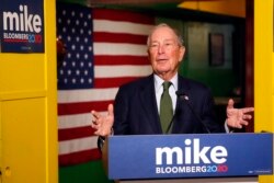 FILE - In this Nov. 26, 2019, file photo, Democratic presidential candidate Michael Bloomberg speaks to the media in Phoenix. Democrats are narrowing Donald Trump's early spending advantage, with two billionaire White House hopefuls joining…