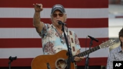 FILE - Singer Jimmy Buffett is shown on Nov. 7, 2016, in St. Petersburg, Fla. Buffett popularized beach bum soft rock with the escapist Caribbean-flavored song “Margaritaville” and turned that celebration of loafing into an empire of restaurants, resorts and frozen concoctions.