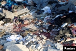 FILE - Blood stains are seen at a detention center for mainly African migrants that was hit by an airstrike in the Tajoura suburb of Tripoli, Libya, July 3, 2019.