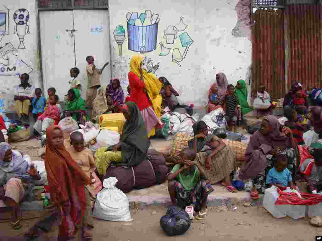 Somali displaced families wait for humanitarian assistance near a street in southern Mogadishu where they rest after fleeing from southern Somalia regions on August 3, 2011. (AFP)