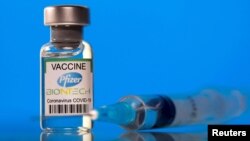 FILE - A vial with the Pfizer-BioNTech COVID-19 vaccine is seen in this illustration picture taken March 19, 2021.