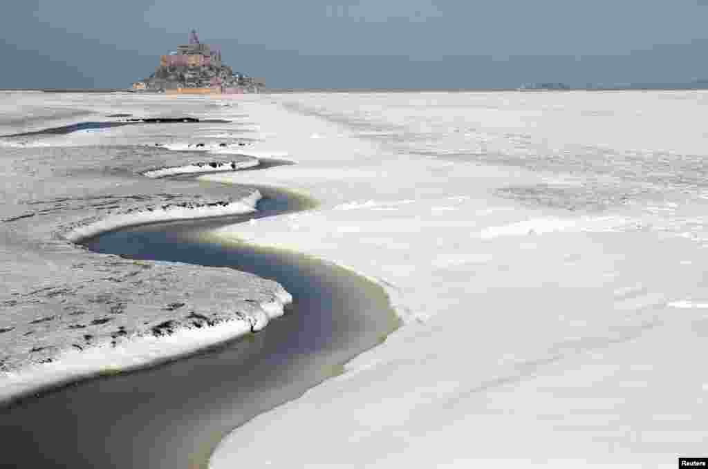 The snow-covered Mont Saint-Michel Bay in the French western region of Normandy is seen as winter weather hits a large northern part of the country.