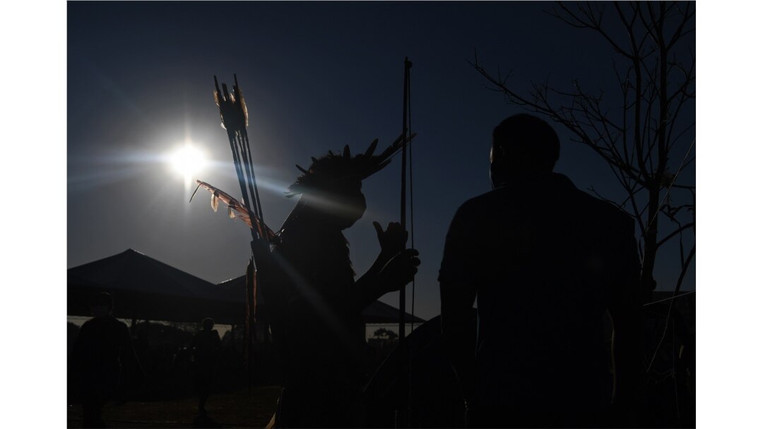 A member of the Kayapo tribe carries bows and arrows at a protest camp in Brasilia, Brazil on Aug. 23, 2021.
