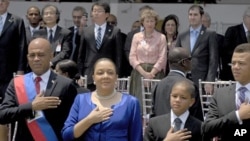 Haiti's President Michel Martelly and family stand for the national anthem during the inauguration ceremony in Port-au-Prince, May 14, 2011