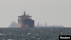 资料照片：从阿拉伯联合酋长国拉斯海玛北部望去，可以见到货轮停在靠近霍尔木兹海峡的波斯湾海域。(2026年3月11日)