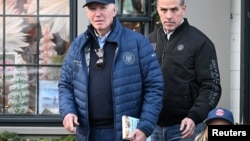 FILE - U.S. President Joe Biden, accompanied by Hunter Biden and Beau Jr., walks out of a bookstore in downtown Nantucket, Massachusetts, November 29, 2024.