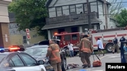 Injured people lie on the ground following a mass shooting in the parking lot of TOPS supermarket, in this still image from a social media video in Buffalo