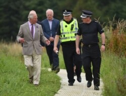 Britain's Prince Charles, Prince of Wales, meets first responders in Stonehaven where a passenger train derailed in northeast Scotland, Aug. 14, 2020.