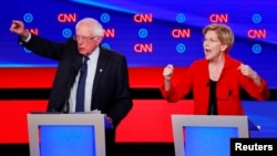 U.S. Senator Bernie Sanders and U.S. Senator Elizabeth Warren speak on the first night of the second 2020 Democratic U.S. presidential debate in Detroit, Michigan, U.S., July 30, 2019. 