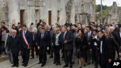 French independent centrist presidential candidate Emmanuel Macron, 3rd left, and his wife Brigitte Macron, center left, visit the ruins in the village of Oradour-sur-Glane, central France, Friday, April 28, 2017. France's troubled wartime past is…