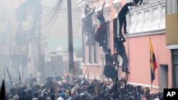 Manifestantes antigubernamentales suben a un edificio en Quito, en protestas que han sacudido a Ecuador, el viernes.