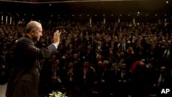 Turkey's President Recep Tayyip Erdogan, waves to the crowd before delivering a speech in Ankara, Turkey, Jan. 27, 2017. Erdogan's government eased some of the laws enacted after a July coup attempt, Jan. 30, 2017. 