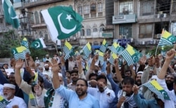 People chant slogans to observe Black Day over India's decision to revoke the special status of Jammu and Kashmir, during a protest in Peshawar, Pakistan, Aug. 15, 2019.