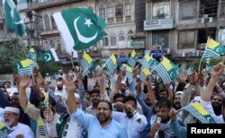 People chant slogans to observe Black Day over India's decision to revoke the special status of Jammu and Kashmir, during a protest in Peshawar, Pakistan, Aug. 15, 2019.