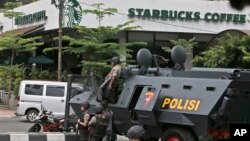 A police armored vehicle is parked outside a Starbucks cafe after an explosion in Jakarta, Indonesia, Jan. 14, 2016. 