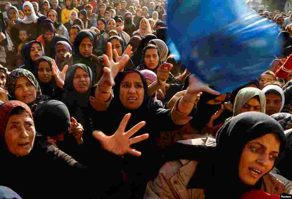 Palestinians gather to buy bread from a bakery, amid the Israel-Hamas conflict, in Khan Younis, in the southern Gaza Strip.