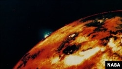  In this computer-enhanced picture from Voyager 1 taken in 1979, blue plume on the horizon consists of material hurled upward from volcano to more than 150 kilometers (about 90 miles) above Io's blotchy red-orange landscape.