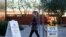 A woman walks to cast her ballot at the register of voters during early voting in Phoenix, Arizona, October 29, 2020.