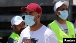 Men wearing protective face masks are seen in downtown Cairo, Egypt, amid concerns about the spread of the coronavirus disease (COVID-19), May 2, 2020.