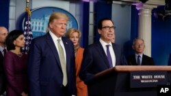 Treasury Secretary Steven Mnuchin speaks during a press briefing with the coronavirus task force, at the White House, March 17, 2020, in Washington, as President Donald Trump looks on. 