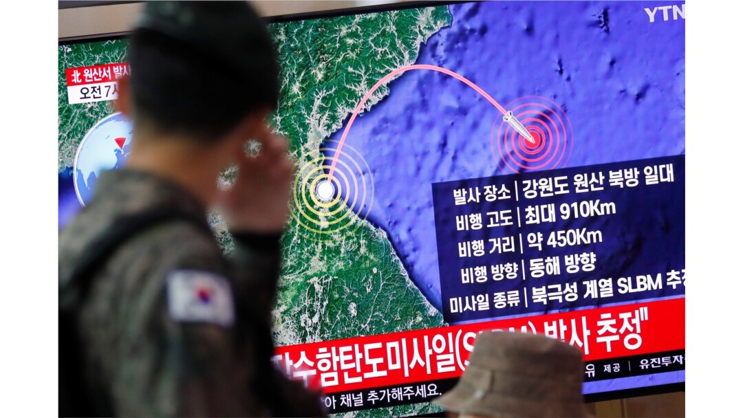 A South Korean soldier walks past a TV broadcasting a news report on North Korea firing a missile that is believed to be launched from a submarine, in Seoul, South Korea, Oct. 2, 2019.