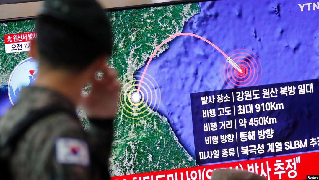 FILE - A South Korean soldier walks past a TV broadcasting a news report on North Korea firing a missile that is believed to be launched from a submarine, in Seoul, South Korea, Oct. 2, 2019. 