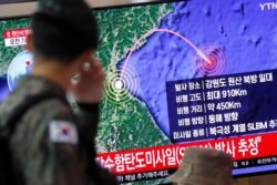 A South Korean soldier walks past a TV broadcasting a news report on North Korea firing a missile that is believed to be launched from a submarine, in Seoul, South Korea, Oct. 2, 2019.